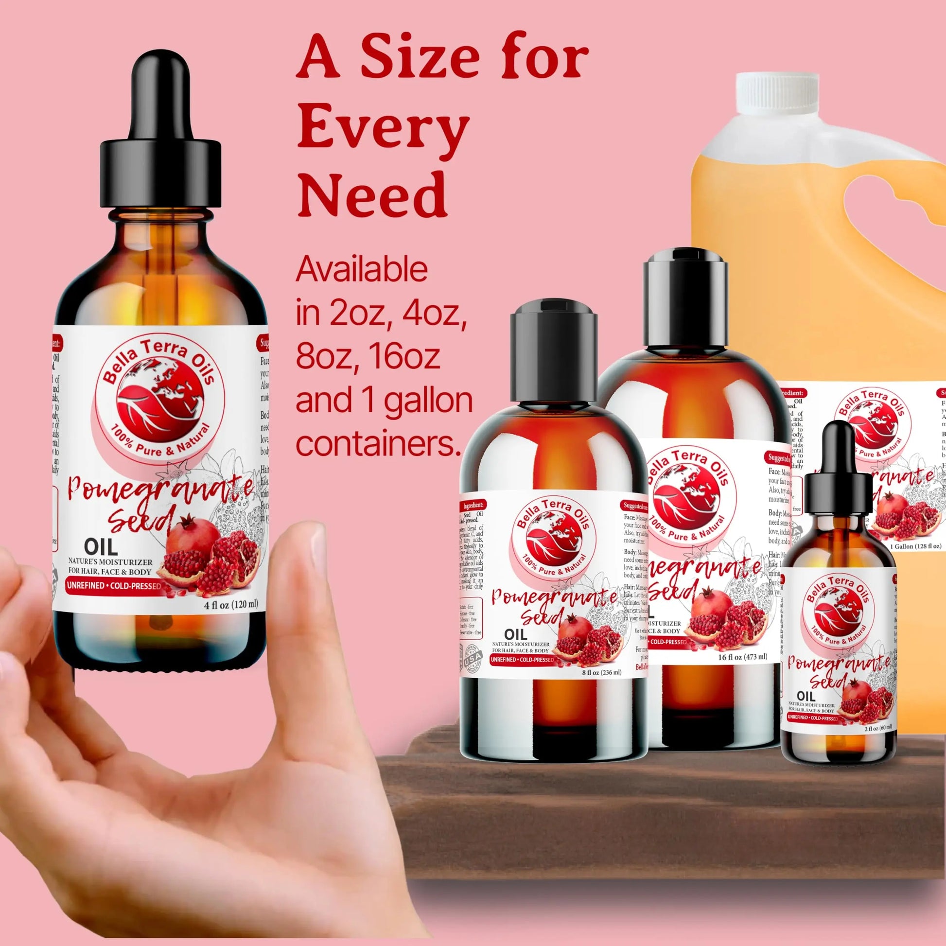 Bella Terra Organics Pomegranate Seed Oil bottles in various sizes with a hand holding one bottle against a pink background.