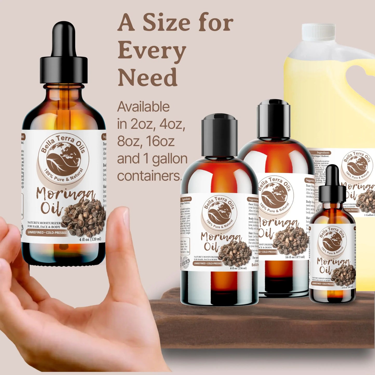 Bella Terra Oils Moringa Oil bottles in various sizes with a hand holding one bottle.